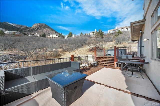 view of patio / terrace with an outdoor hangout area and a deck with mountain view