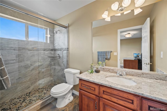 bathroom featuring walk in shower, vanity, and toilet