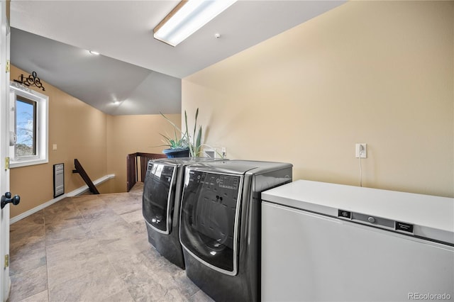 clothes washing area with washing machine and dryer