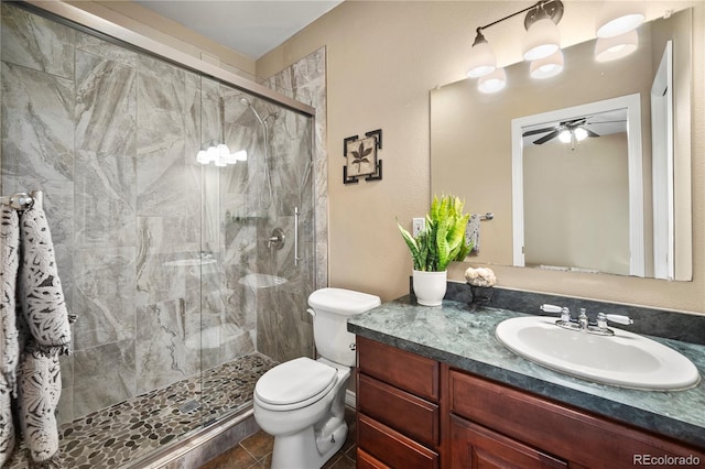 bathroom featuring vanity, an enclosed shower, ceiling fan, and toilet