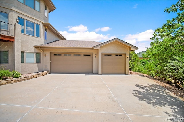 3325 Blodgett, Colorado Springs, CO 80919 - view of front of property featuring driveway, an attached garage, and stucco siding