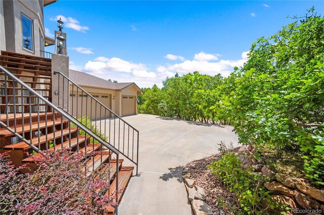 3325 Blodgett, Colorado Springs, CO 80919 - view of yard featuring stairway, driveway, and a garage
