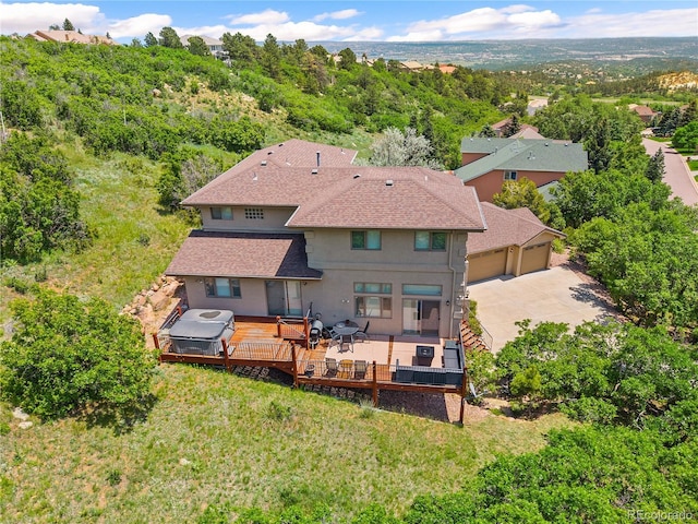 3325 Blodgett, Colorado Springs, CO 80919 - rear view of property with stucco siding, roof with shingles, a wooden deck, a garage, and concrete driveway