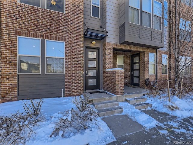 view of snow covered property entrance