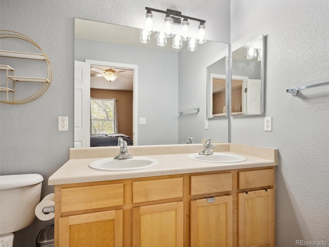 bathroom with ceiling fan, vanity, and toilet