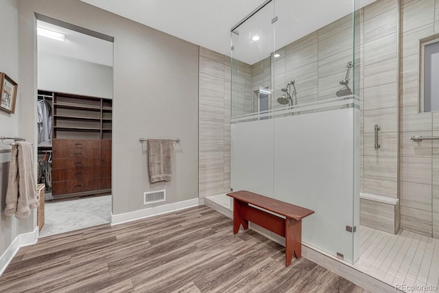 788 Alumroot St, Castle Rock, CO 80104 - full bath featuring walk in shower, wood finished floors, a walk in closet, and baseboards