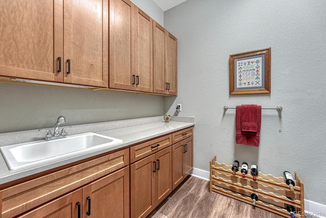788 Alumroot St, Castle Rock, CO 80104 - laundry room with dark wood-type flooring, cabinet space, and baseboards