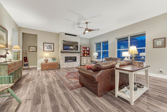788 Alumroot St, Castle Rock, CO 80104 - living room with wood finished floors, a ceiling fan, a fireplace, and baseboards