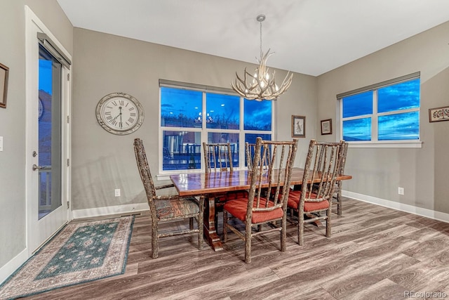 788 Alumroot St, Castle Rock, CO 80104 - dining room featuring a chandelier, wood finished floors, and baseboards