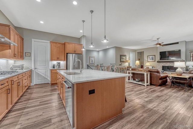 788 Alumroot St, Castle Rock, CO 80104 - kitchen with a ceiling fan, decorative backsplash, light wood-style flooring, and recessed lighting