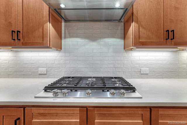 788 Alumroot St, Castle Rock, CO 80104 - kitchen featuring stainless steel gas cooktop, light countertops, and brown cabinetry