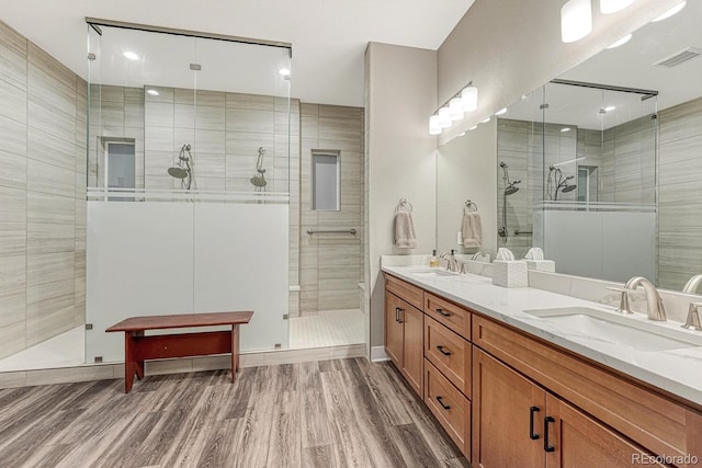 788 Alumroot St, Castle Rock, CO 80104 - full bathroom featuring wood finished floors, double vanity, and a stall shower