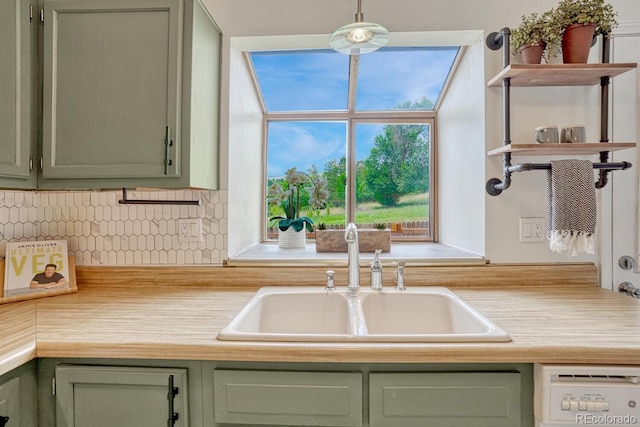 458 Rolling Hills Dr, Colorado Springs, CO 80919 - kitchen with green cabinetry, light countertops, white dishwasher, and backsplash