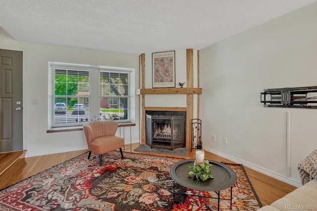 458 Rolling Hills Dr, Colorado Springs, CO 80919 - living area featuring wood finished floors, a fireplace, and a textured ceiling