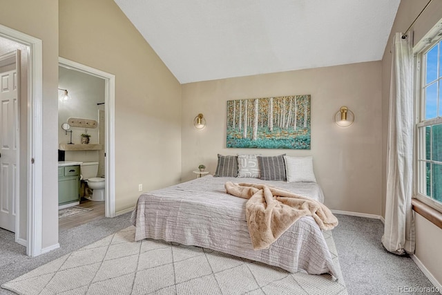 458 Rolling Hills Dr, Colorado Springs, CO 80919 - bedroom with lofted ceiling, light carpet, and connected bathroom