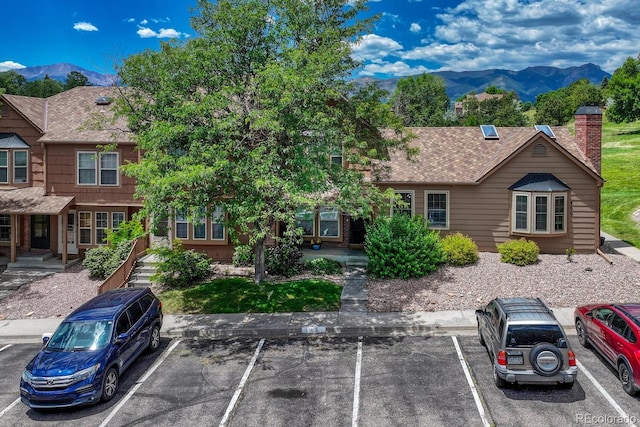 458 Rolling Hills Dr, Colorado Springs, CO 80919 - view of front of house featuring a mountain view, uncovered parking, and a chimney