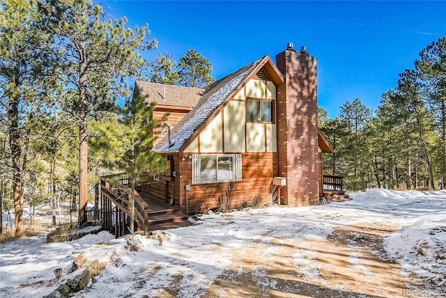 view of snowy exterior with a deck