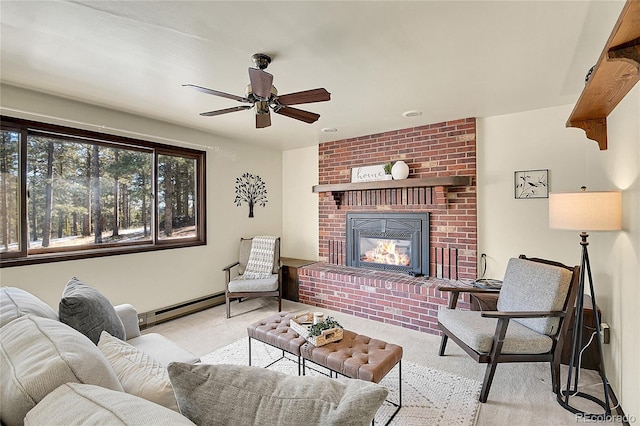 living room featuring ceiling fan, a fireplace, and a baseboard heating unit