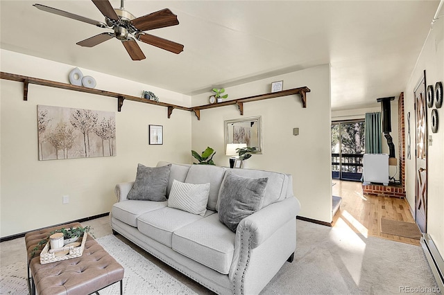 living room with ceiling fan and a baseboard heating unit