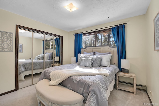 carpeted bedroom with a baseboard radiator, a closet, and a textured ceiling