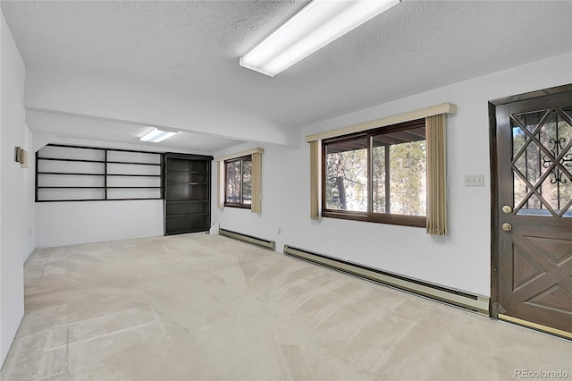 interior space with a baseboard radiator and a textured ceiling