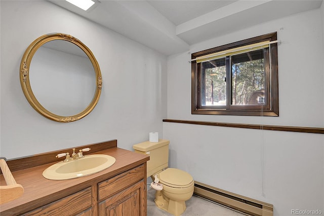 bathroom featuring vanity, toilet, and baseboard heating