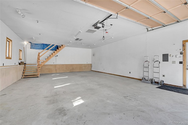 garage featuring a garage door opener and electric panel