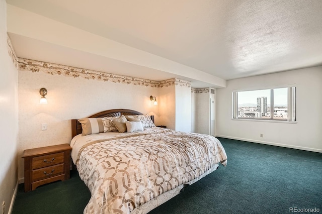 carpeted bedroom with baseboards and a textured ceiling