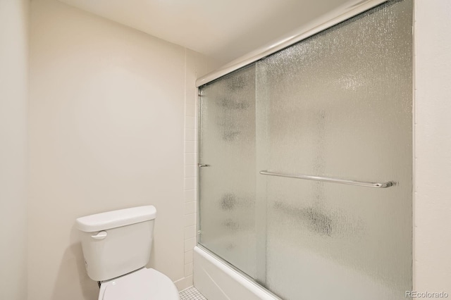 bathroom with enclosed tub / shower combo and toilet