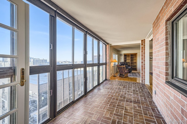 unfurnished sunroom featuring a view of city