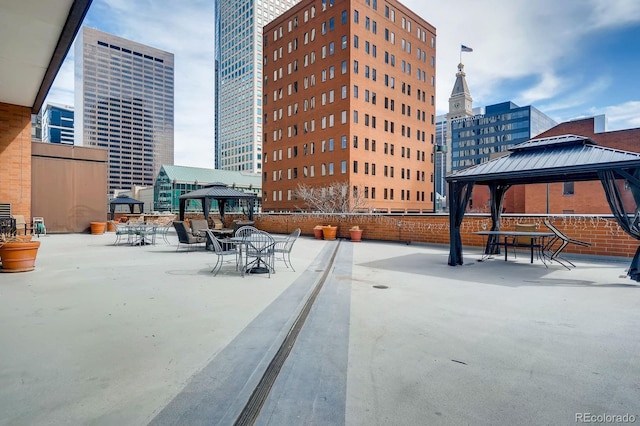 view of patio featuring a gazebo and a view of city