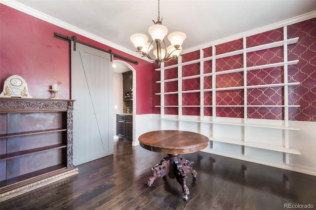 10525 Mt Sherman Way, Peyton, CO 80831 - unfurnished dining area featuring arched walkways, ornamental molding, wood finished floors, wainscoting, and a barn door
