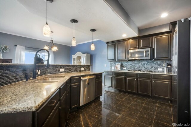 10525 Mt Sherman Way, Peyton, CO 80831 - kitchen with appliances with stainless steel finishes, a sink, dark brown cabinets, tasteful backsplash, and ornamental molding