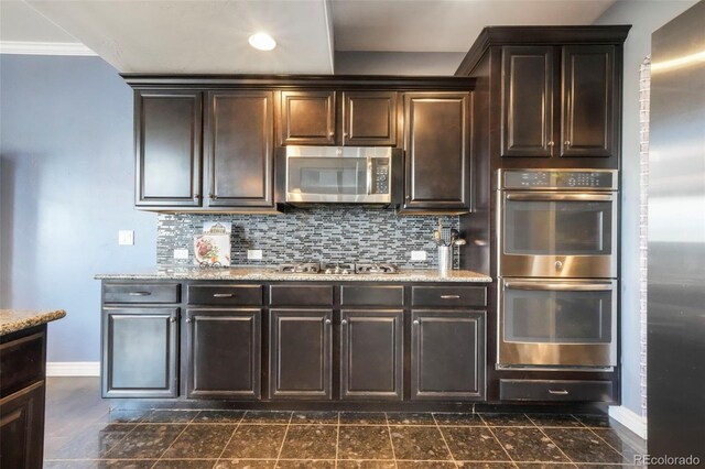 10525 Mt Sherman Way, Peyton, CO 80831 - kitchen featuring appliances with stainless steel finishes, baseboards, dark brown cabinets, and recessed lighting