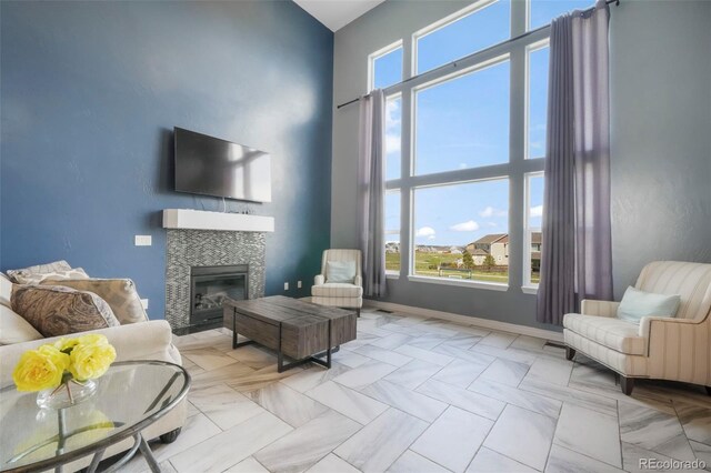 10525 Mt Sherman Way, Peyton, CO 80831 - living area with a high ceiling, a tile fireplace, and baseboards