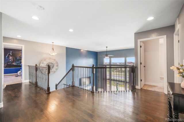 10525 Mt Sherman Way, Peyton, CO 80831 - hall featuring an upstairs landing, wood finished floors, baseboards, and recessed lighting