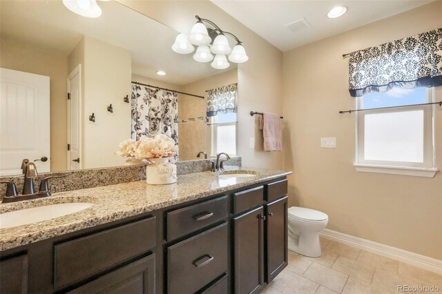 10525 Mt Sherman Way, Peyton, CO 80831 - bathroom featuring toilet, double vanity, tile patterned floors, baseboards, and a shower with curtain