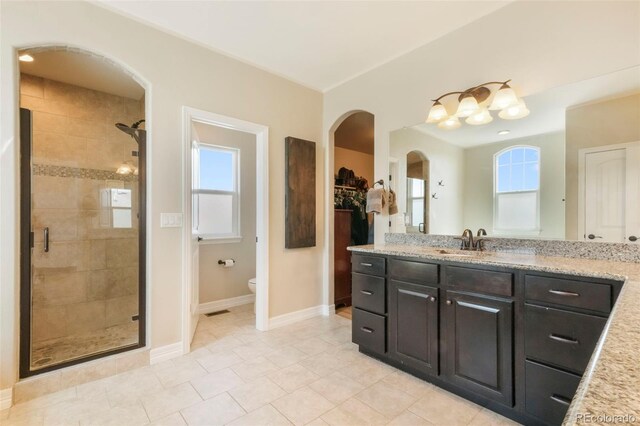 10525 Mt Sherman Way, Peyton, CO 80831 - bathroom with a shower stall, vanity, toilet, and baseboards