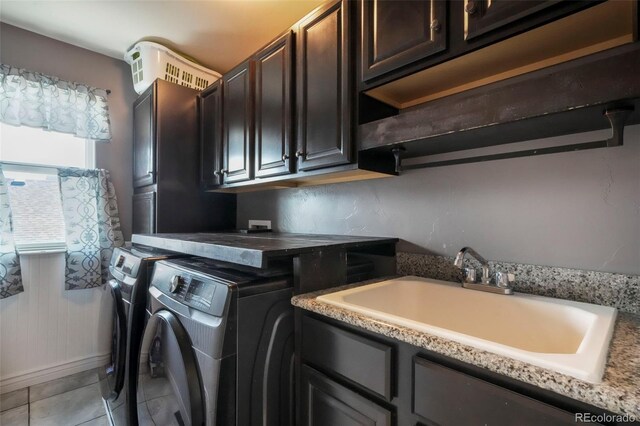 10525 Mt Sherman Way, Peyton, CO 80831 - laundry area featuring cabinet space, washer and clothes dryer, and light tile patterned flooring