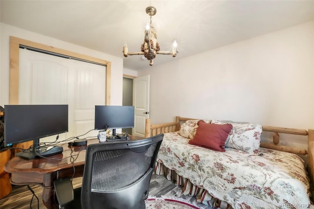 10525 Mt Sherman Way, Peyton, CO 80831 - bedroom featuring a chandelier, an office area, a closet, and wood finished floors