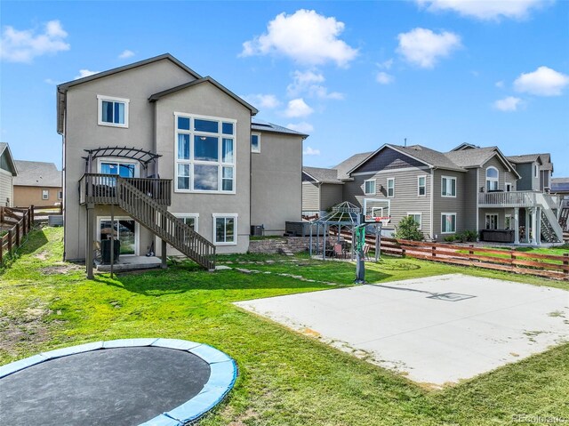 10525 Mt Sherman Way, Peyton, CO 80831 - back of house with stairs, stucco siding, a residential view, and basketball court