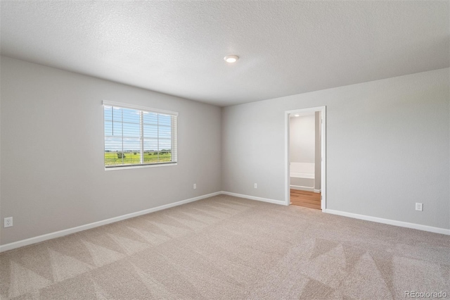 7220 Dolores Ave, Frederick, CO 80530 - spare room with light colored carpet, baseboards, and a textured ceiling