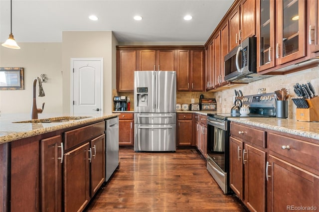 2043 S Cathay Way, Aurora, CO 80013 - kitchen with stainless steel appliances, light stone countertops, dark wood-style flooring, tasteful backsplash, and recessed lighting