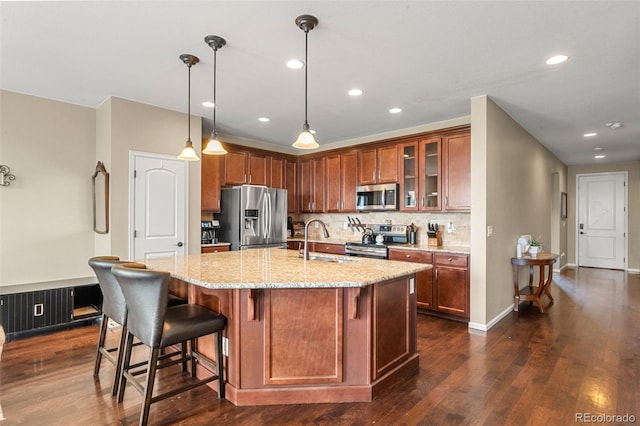 2043 S Cathay Way, Aurora, CO 80013 - kitchen with stainless steel appliances, dark wood finished floors, light stone countertops, glass insert cabinets, and a breakfast bar area