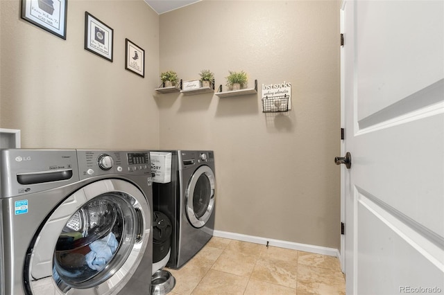 2043 S Cathay Way, Aurora, CO 80013 - washroom featuring washer and clothes dryer and light tile patterned floors