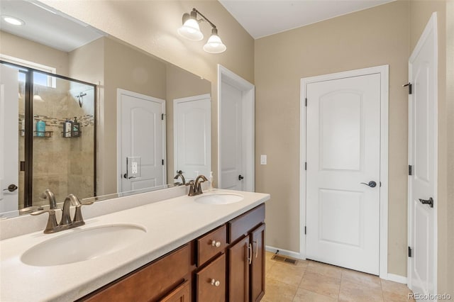 2043 S Cathay Way, Aurora, CO 80013 - bathroom featuring double vanity, a stall shower, and tile patterned flooring