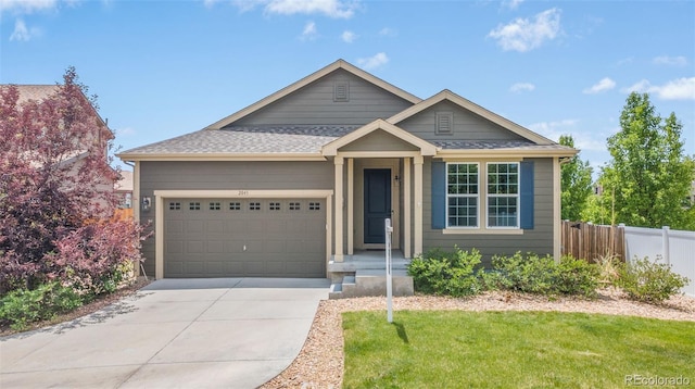 2043 S Cathay Way, Aurora, CO 80013 - view of front of property with an attached garage, driveway, and a shingled roof