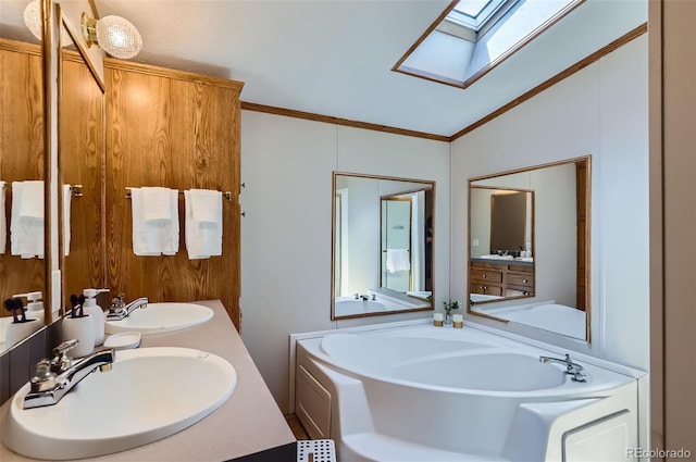 3715 Mcavoy Ave, Evans, CO 80620 - bathroom with a skylight, a garden tub, double vanity, ornamental molding, and lofted ceiling