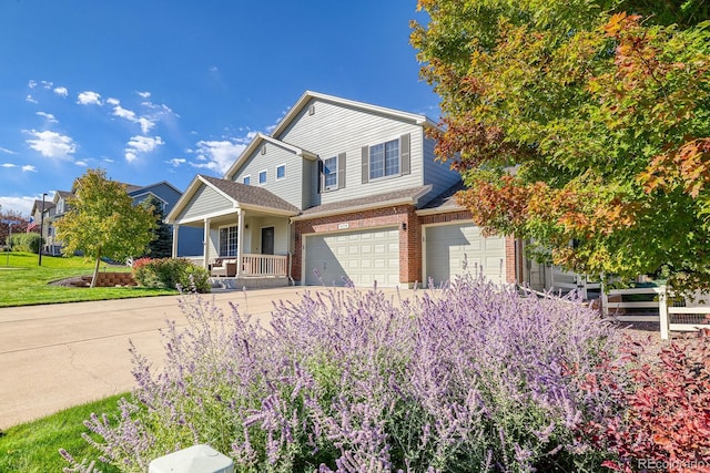 3779 Aspen Hollow Ct, Castle Rock, CO 80104 - traditional home featuring an attached garage, a porch, concrete driveway, and brick siding