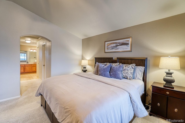3779 Aspen Hollow Ct, Castle Rock, CO 80104 - bedroom featuring arched walkways, light carpet, ensuite bathroom, and baseboards